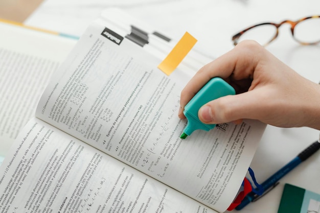 Photo person using a blue highlighter pen photo