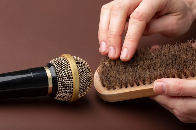 Photo person using brush close to microphone for asmr