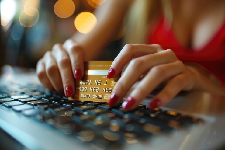 Photo person using a credit card on a laptop
