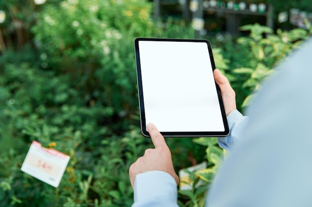 Person using a digital tablet in a flower shop