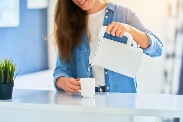 Person using an electric kettle