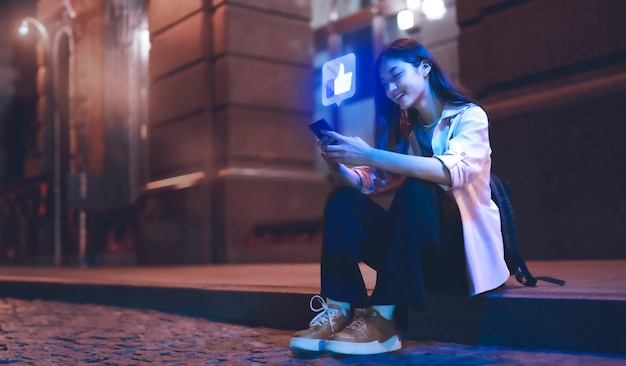 Person using electronic device with social network-related bubbles around them to celebrate social media day