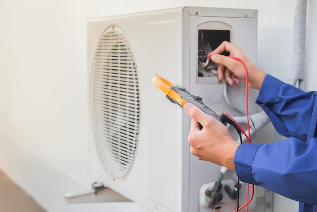 A person using a fan to fix a fan