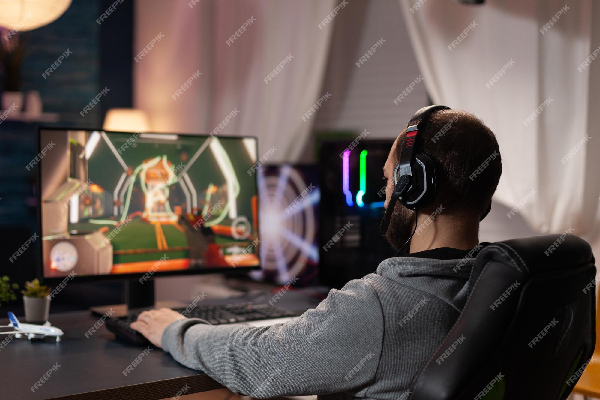 Gamer using controller to play online video games on computer. Man playing  game with joystick and headphones in front of monitor. Player having gaming  equipment, doing fun activity Stock Photo - Alamy