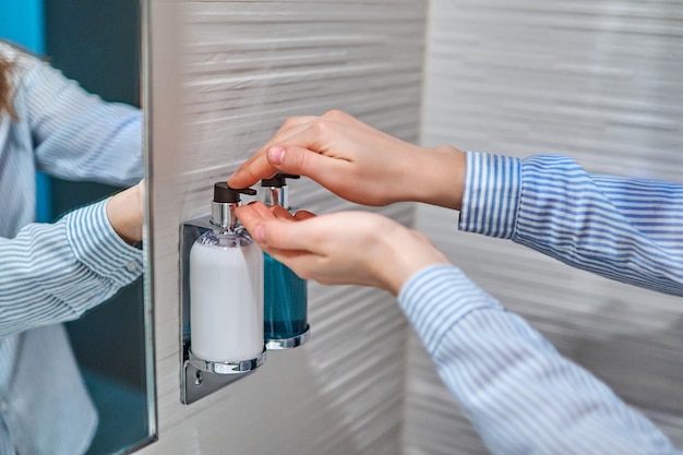 Person using liquid soap to disinfect and wash hands