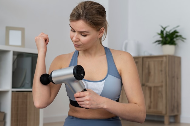 person using massage gun