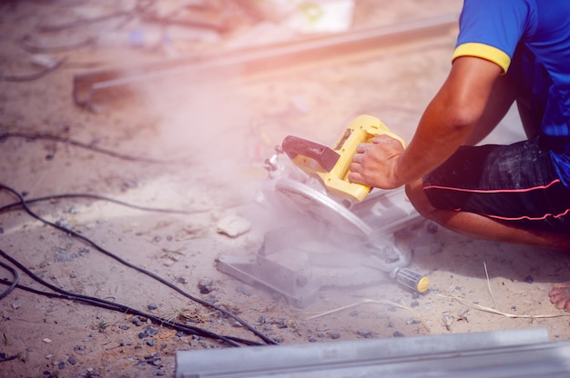 Person using yellow stone cutter