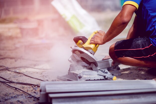 Person using yellow stone cutter