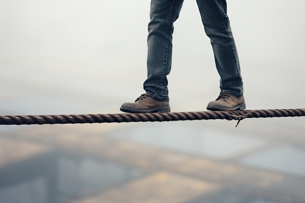 A person walking across a rope