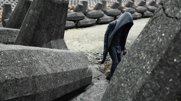 person walking by tetrapods on field