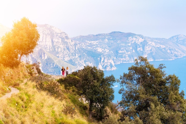 Person walking on scenic coastal path on Amalfi coast in Italy