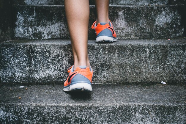 A person walking up a set of steps with the word gym on them