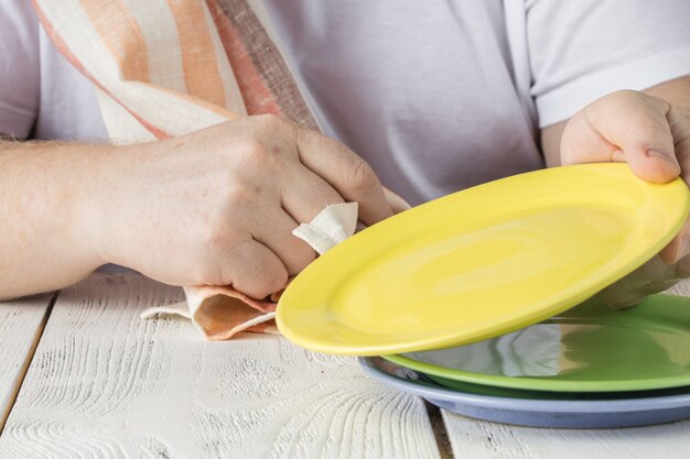 洗剤で食器を洗う人