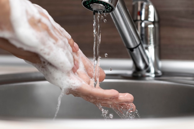 Person washing hands in a sink close-up