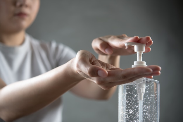 Person washing hands with alcohol gel for disinfection hygiene and protection.