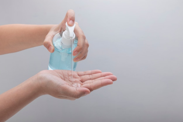 Person washing hands with alcohol gel