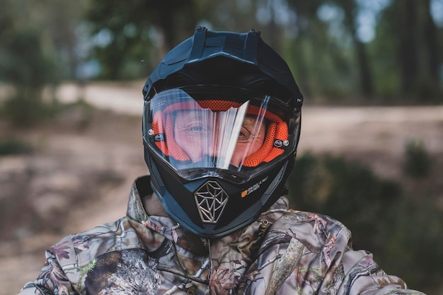 A person wearing a helmet with a logo on the front