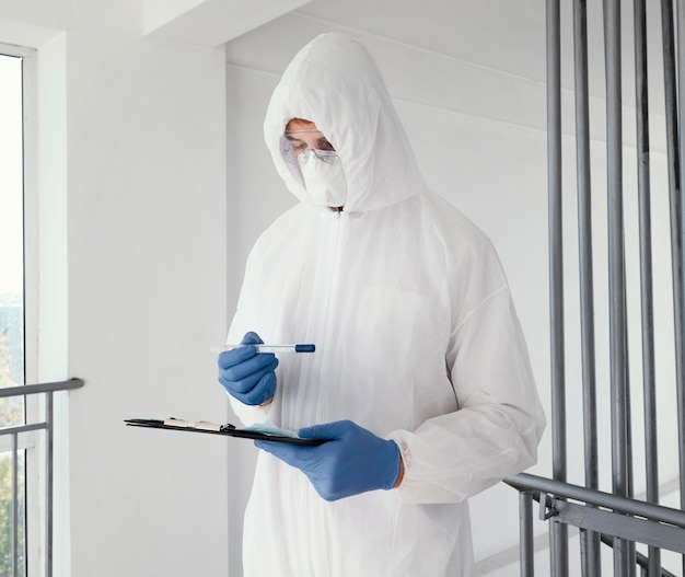 Photo person wearing a prevention suit and taking samples