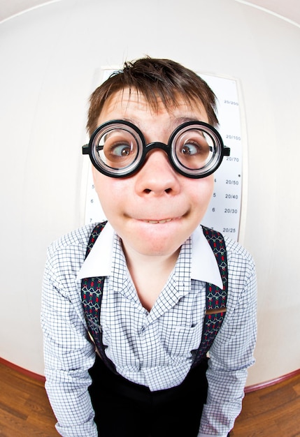 person wearing spectacles in an office at the doctor