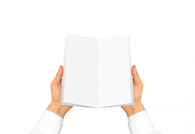 Person in white shirt sleeve holding blank book