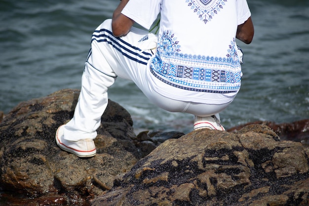 A person who is a fan of candomble on the beachfront paying homage to iemanja on Rio Vermelho beach in Salvador Bahia