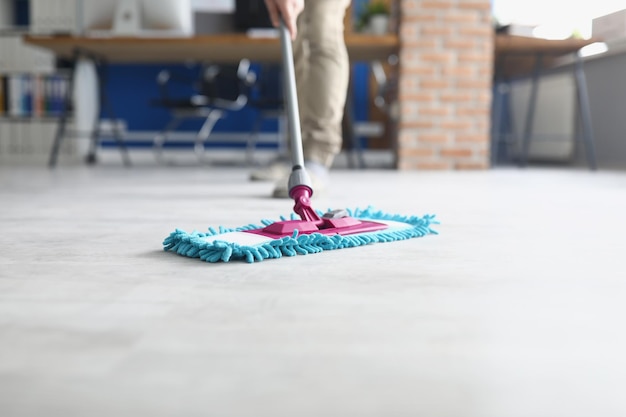 Person wiping floor with fluffy mop domestic work housewife\
cleaning at home