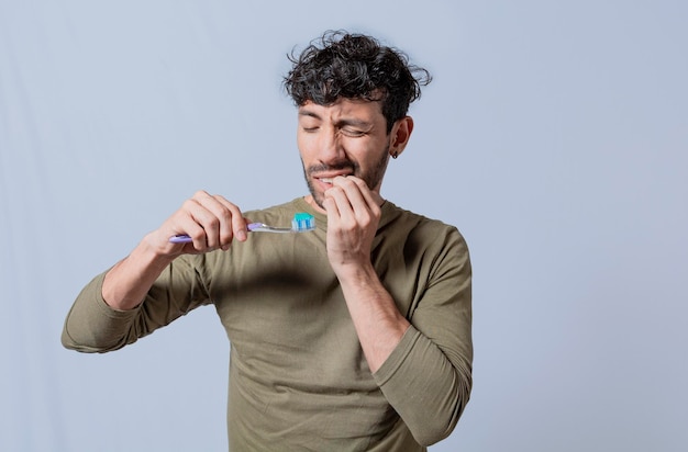 Person with gingivitis holding toothbrush People holding toothbrush with gum pain Man holding toothbrush with gum pain People holding toothbrush with gum problem isolated