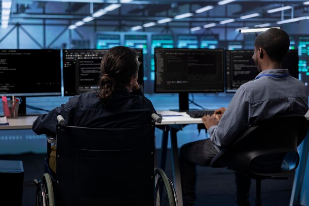 Person with paraplegia and colleague working in inclusive server hub workspace