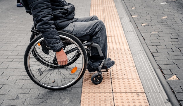 Person with a physical disability waiting for city transport with an accessible ramp