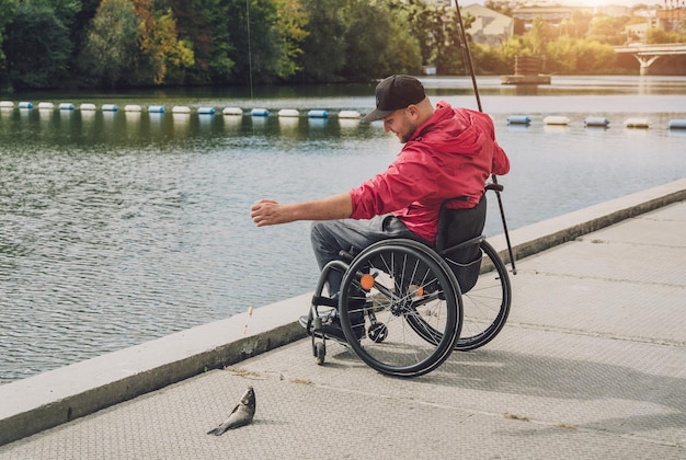 Person with a physical disability in a wheelchair fishing from fishing pier