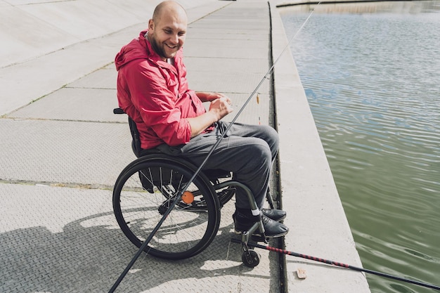 Person with a physical disability in a wheelchair fishing from
fishing pier