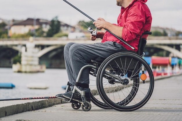 Person with a physical disability in a wheelchair fishing from fishing pier