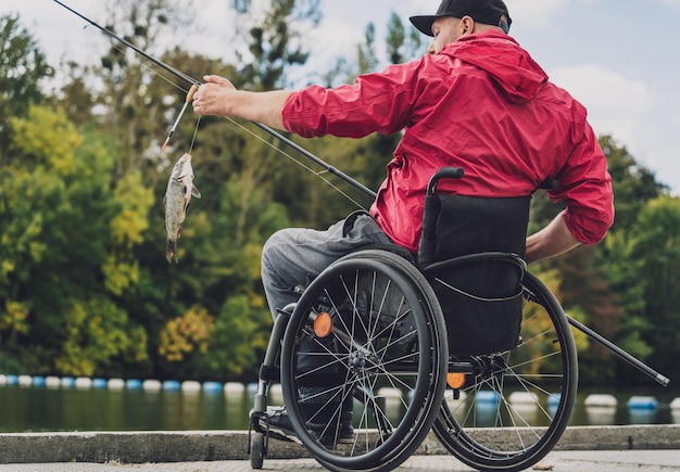 Person with a physical disability in a wheelchair fishing from fishing pier