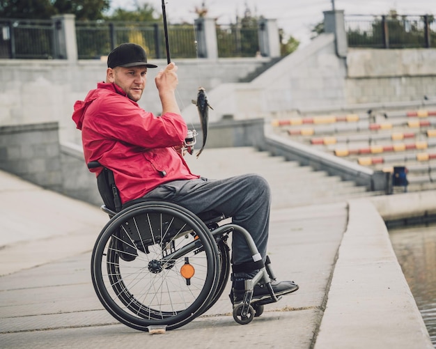 Person with a physical disability in a wheelchair fishing from fishing pier