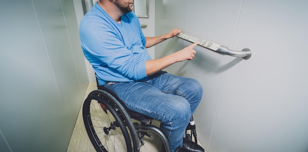 Person with a physical disability in a wheelchair using lift in
building