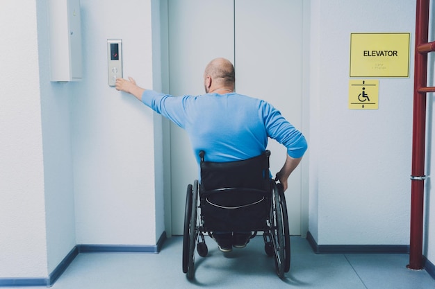 Person with a physical disability in a wheelchair using lift in
building