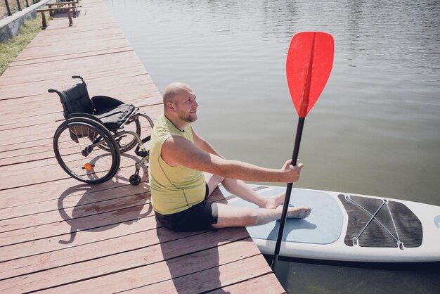 Person with a physical disability in a wheelchair will be ride\
on sup board