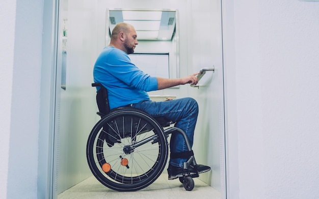 Person with a physical disability who uses wheelchair using\
lift in building