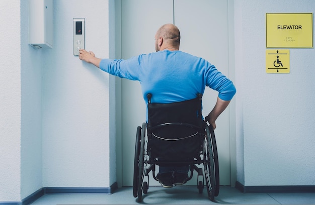 Person with a physical disability who uses wheelchair using\
lift in building