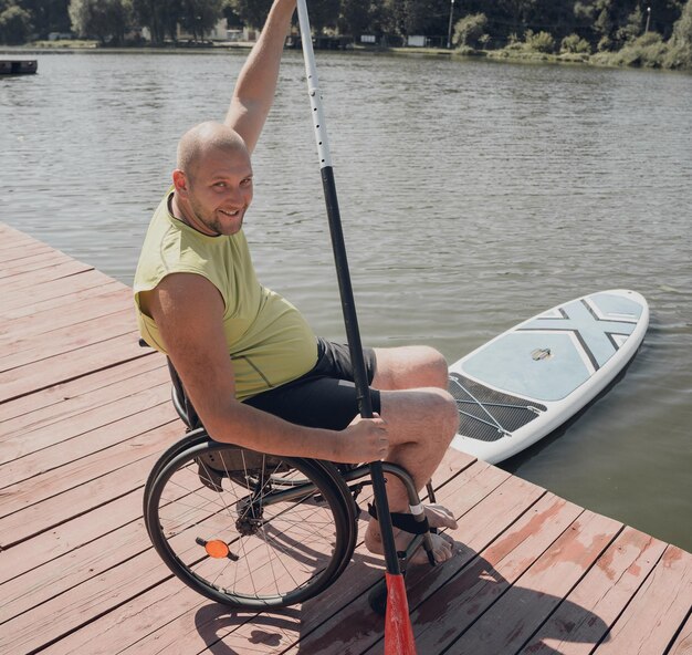 Person with a physical disability who uses wheelchair will be ride on sup board