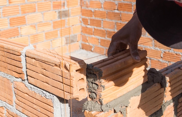 Photo person working on brick wall