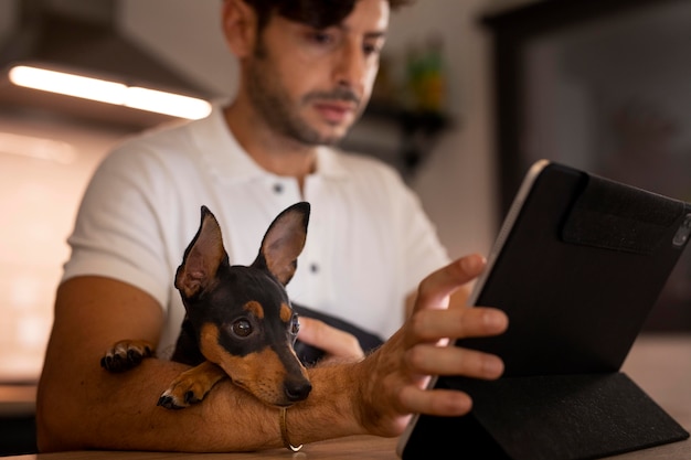 Foto persona che lavora da casa con un cane