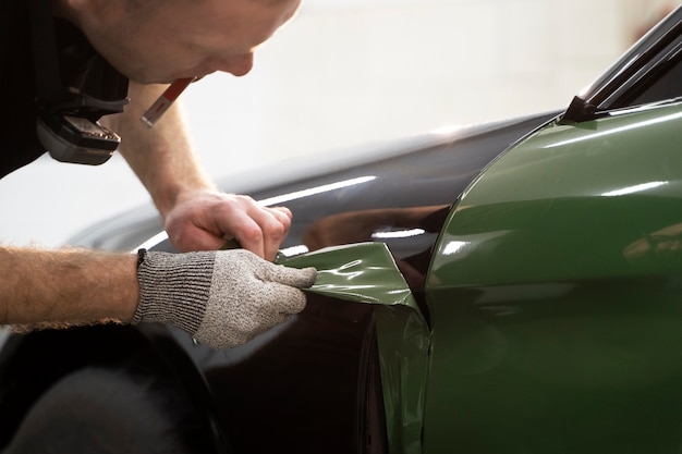 写真 車のラッピングに取り組んでいる人