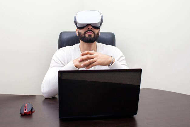 Person in the workplace with VR glasses plays virtual reality the employee looks into virtual space