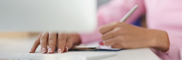 Person writing down ideas in journal on working place making notes for future