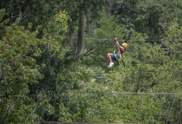 A person zip lining through the trees