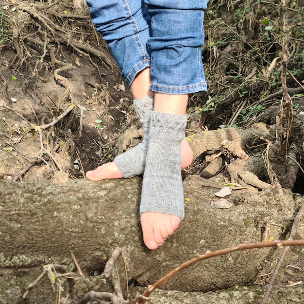 A person039s feet in socks on a log