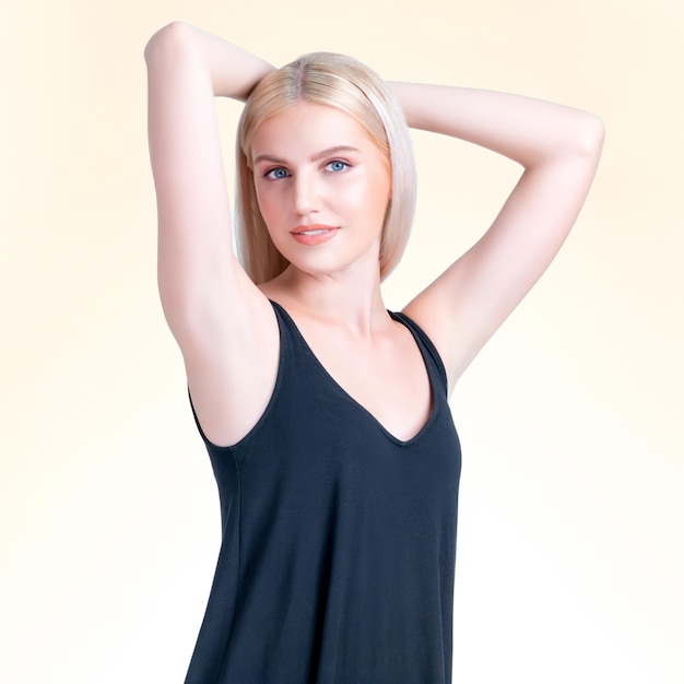 Personable woman lifting her armpit showing clean and hygiene underarm