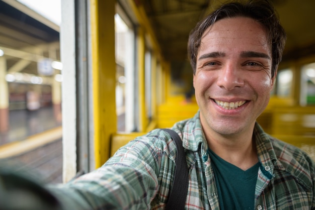 Personal point of view of Persian tourist man taking selfie in train