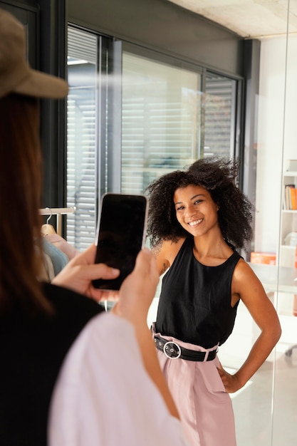 Personal shopper at office with client taking photos